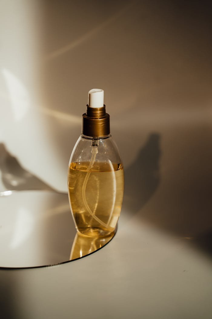Yellow Liquid Filled Clear Glass Bottle
